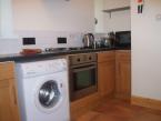 The well-equipped kitchen has garden access