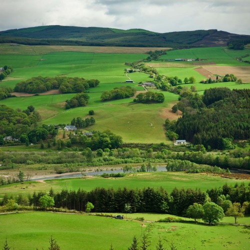 River between hills and fields.