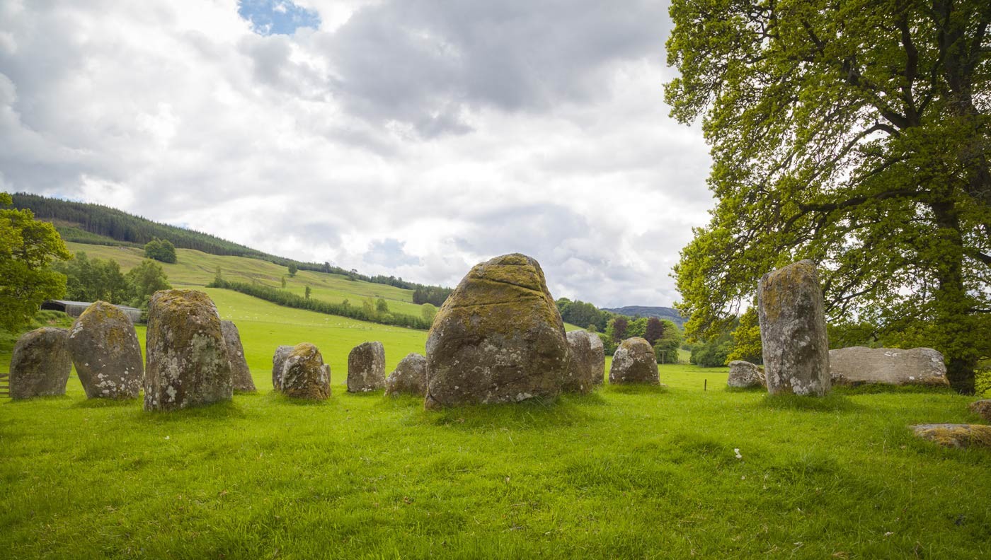Aberfeldy Standing stone circle in a green field, on a bright, yet overcast day
