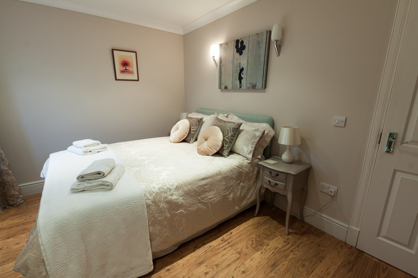 Double bedroom with painting and bedside table