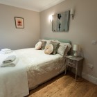 Double bedroom with painting and bedside table