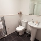 Bathroom with towel radiator, toilet and sink.