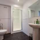 Bathroom with shower, toilet and sink.