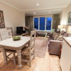 Dining room table and chairs and sofas.