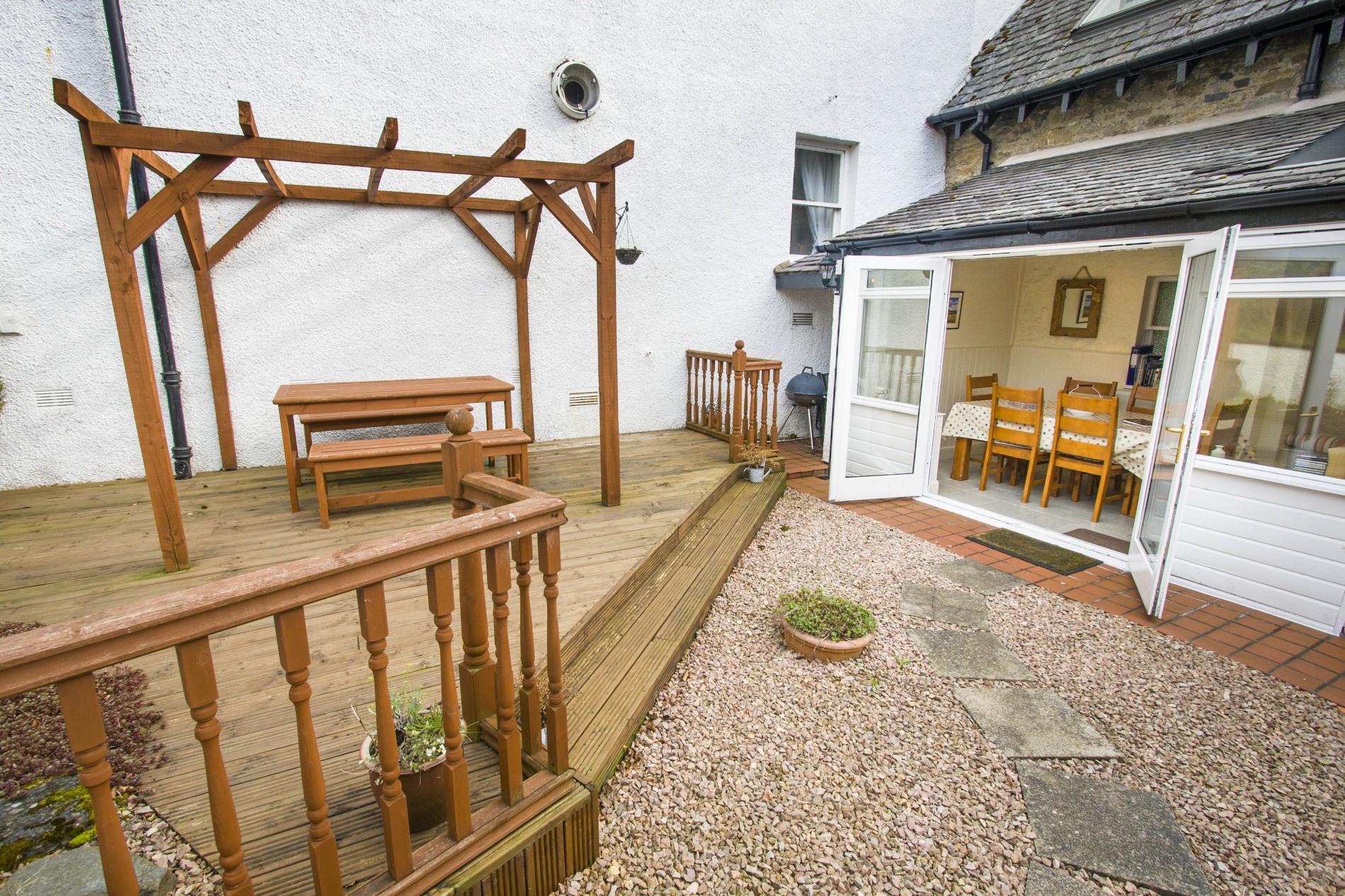 Wooden decking and stone path leading to dining room.