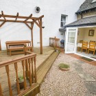 Wooden decking and stone path leading to dining room.