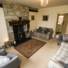 Living room with 2 sofas, 2 arm chairs, TV and fireplace.