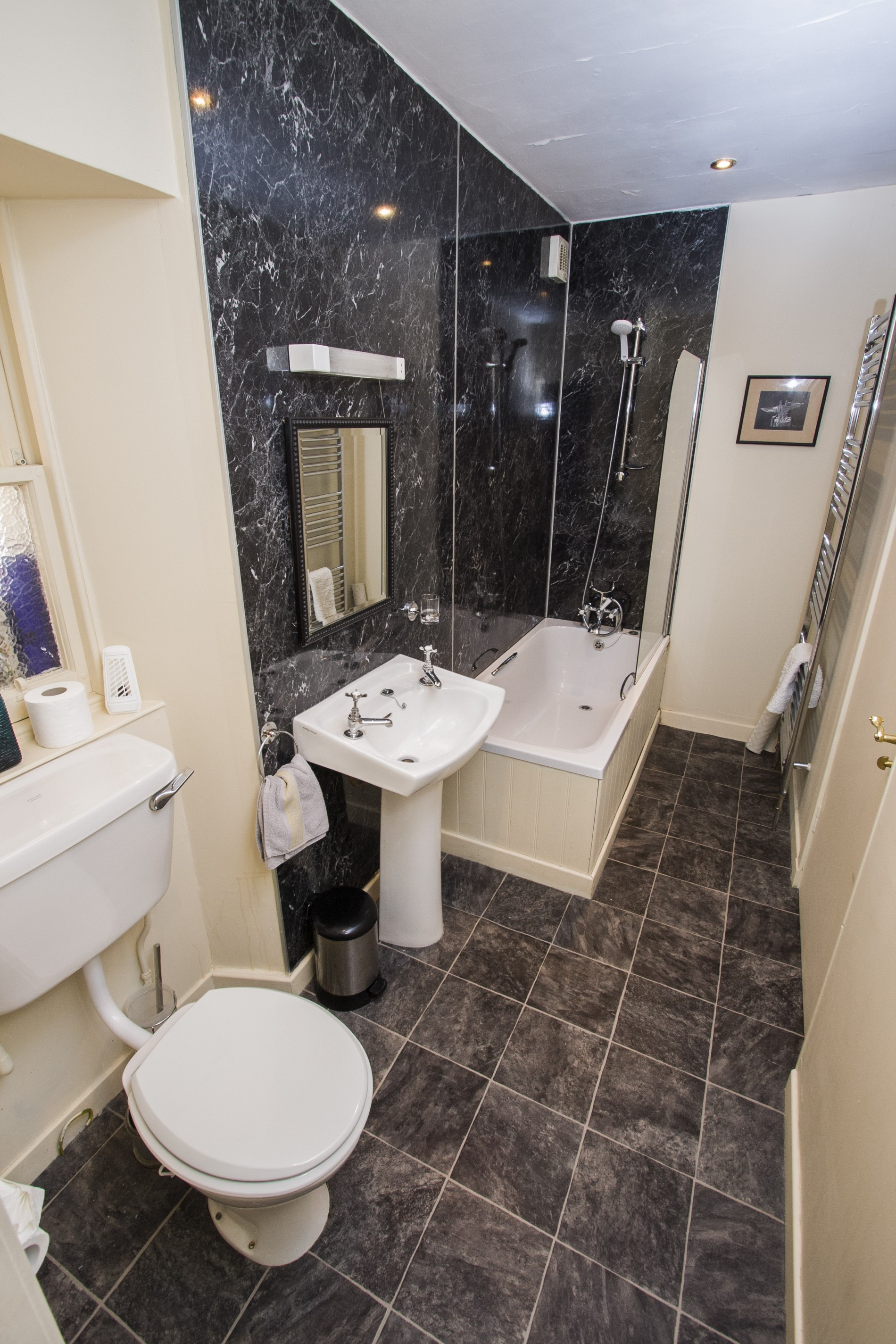 Bathroom with shower/ bath, sink and toilet.