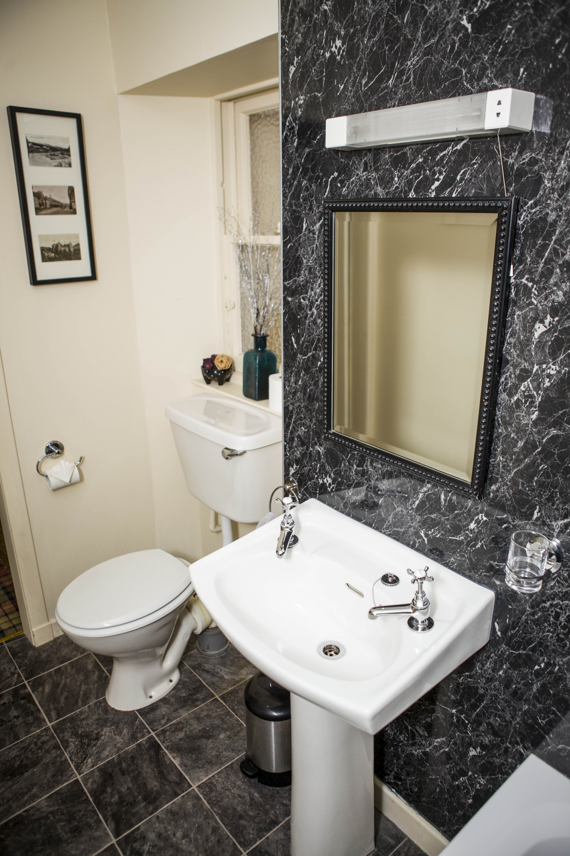 Bathroom with toilet, sink and mirror.