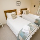 Twin room with window and bedside tables.