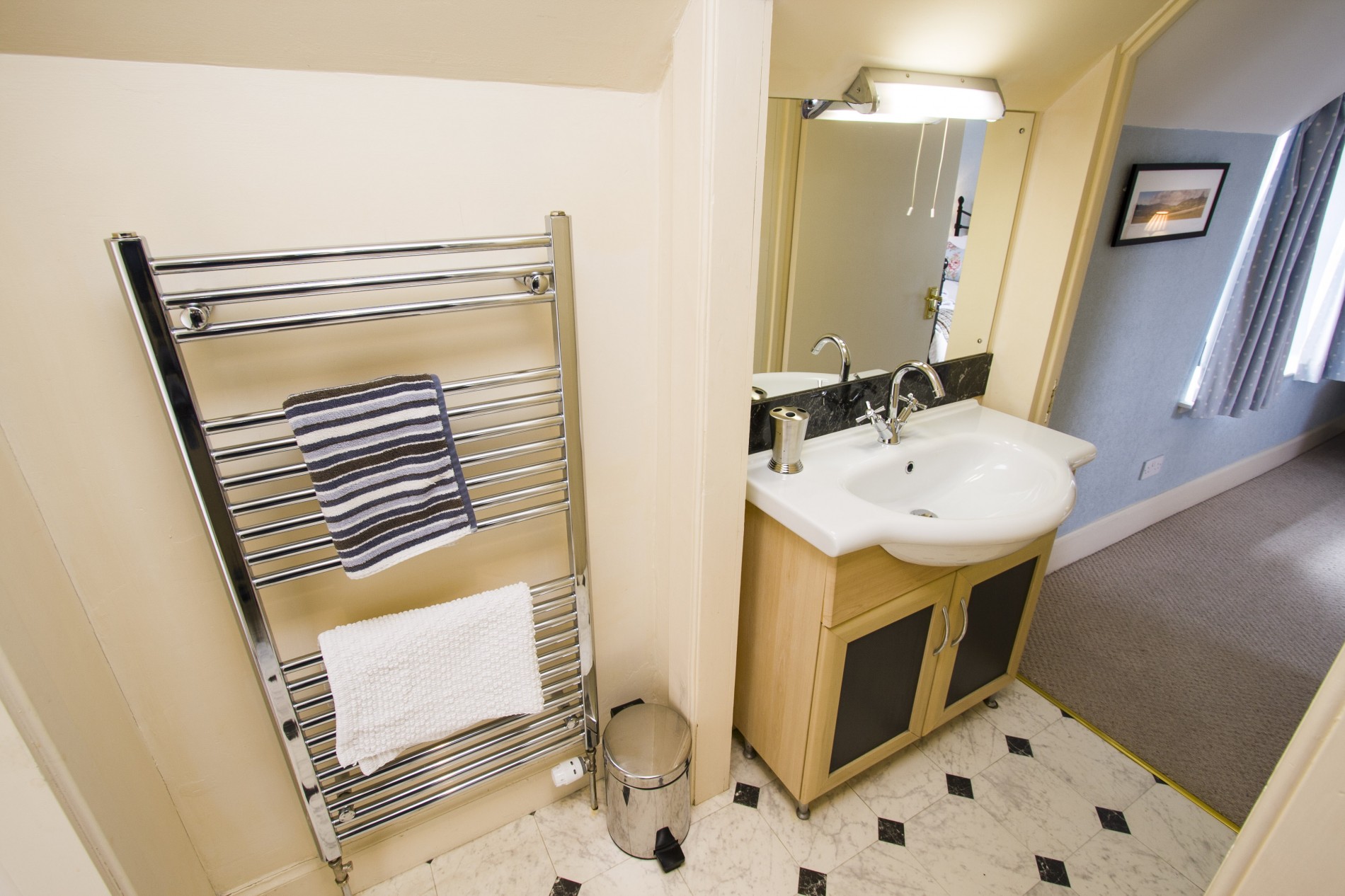 Bathroom with sink and towel rack radiator.