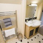 Bathroom with sink and towel rack radiator.