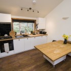 Kitchen counter with cooker, sink and movable island.