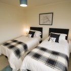 Twin bedroom, each with bedside table.