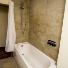 Bath and shower combo with a shower curtain.