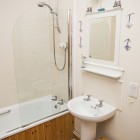 Bright and spacious Bathroom with shower over bath, WC and wash hand basin