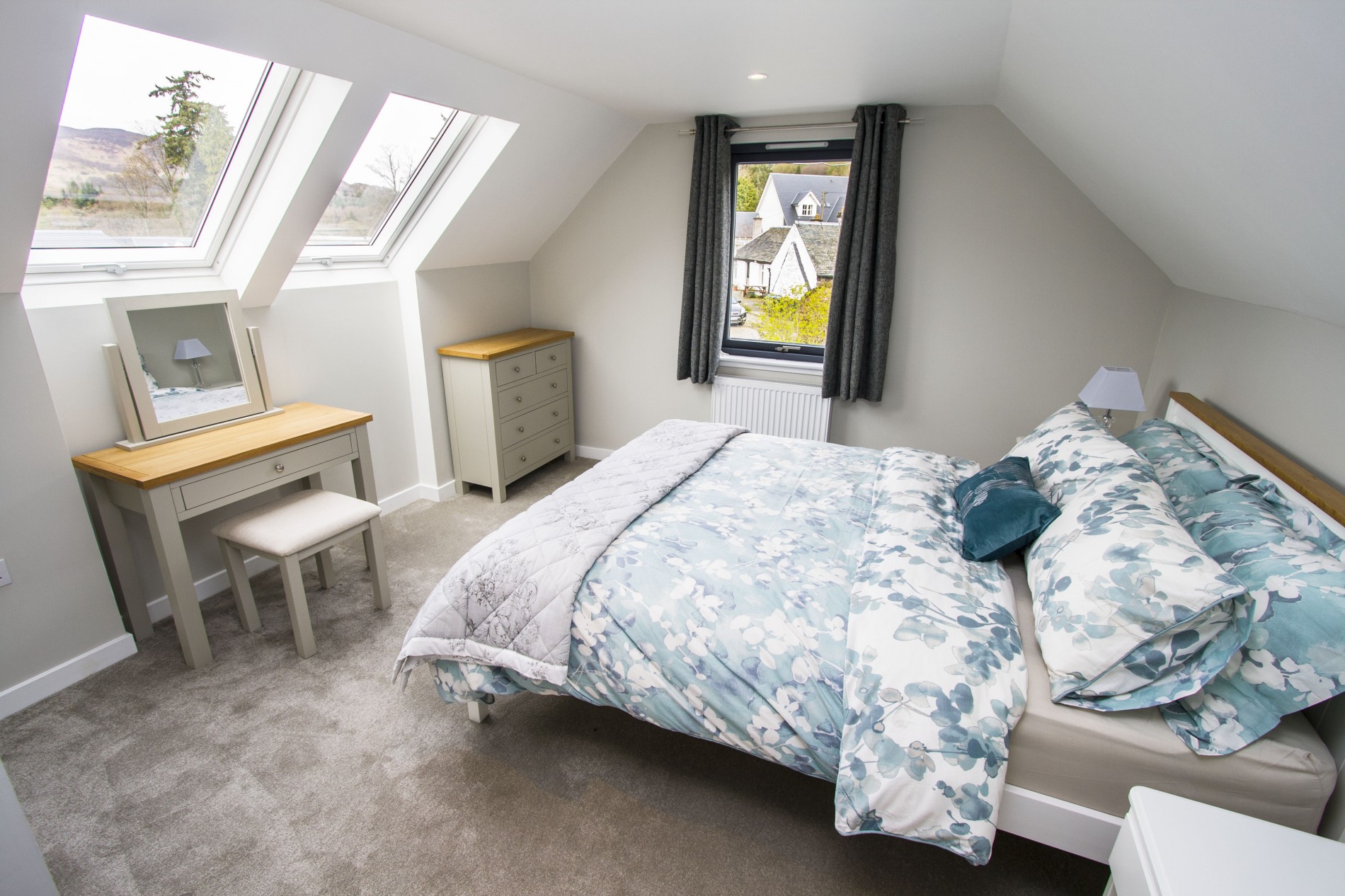 Master bedroom with twin velux roof lights and double glazed windows flooding the room with natural light