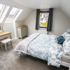 Master bedroom with twin velux roof lights and double glazed windows flooding the room with natural light