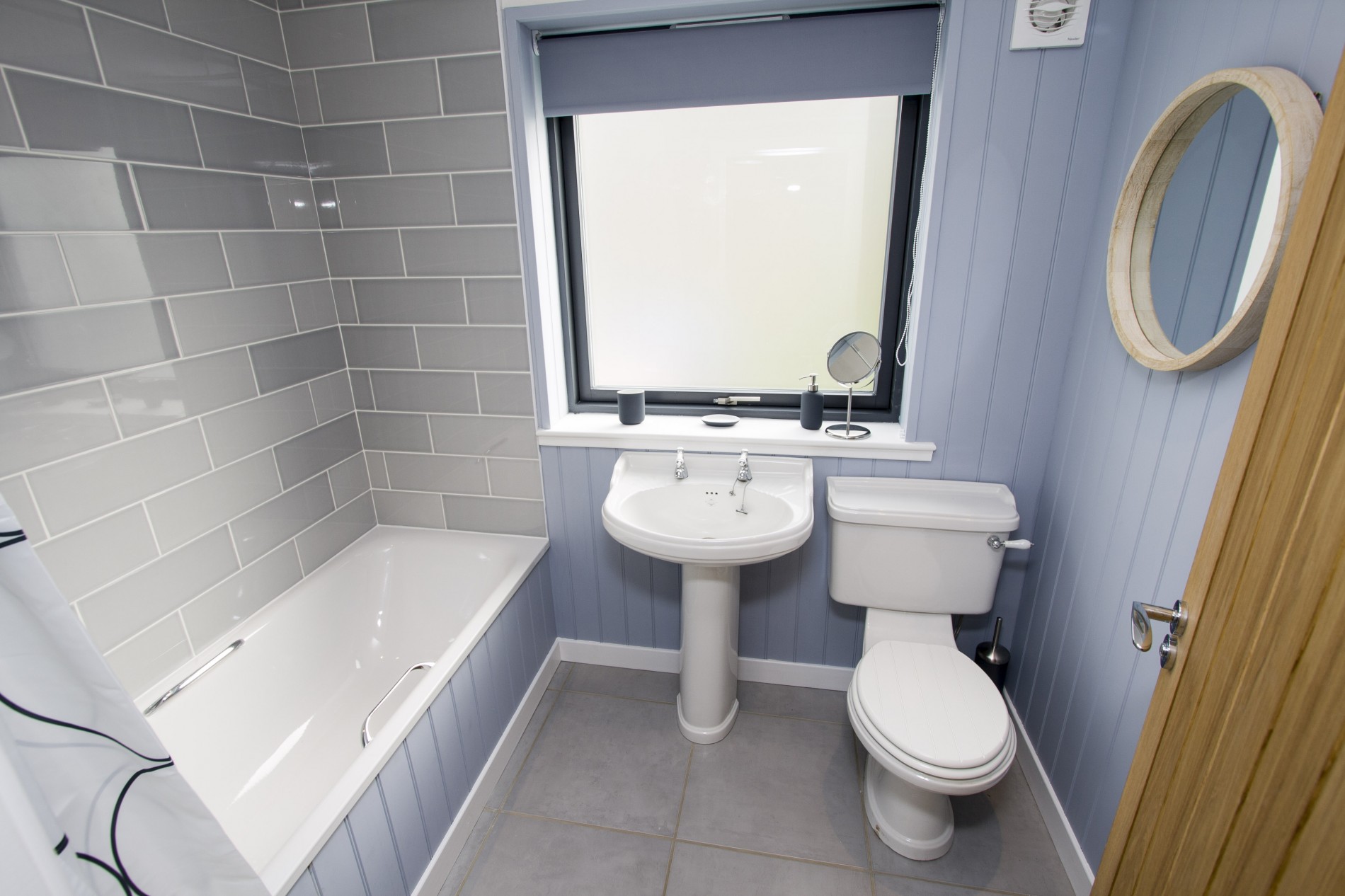 Family bathroom featuring WC, wash hand basin and bath with shower over