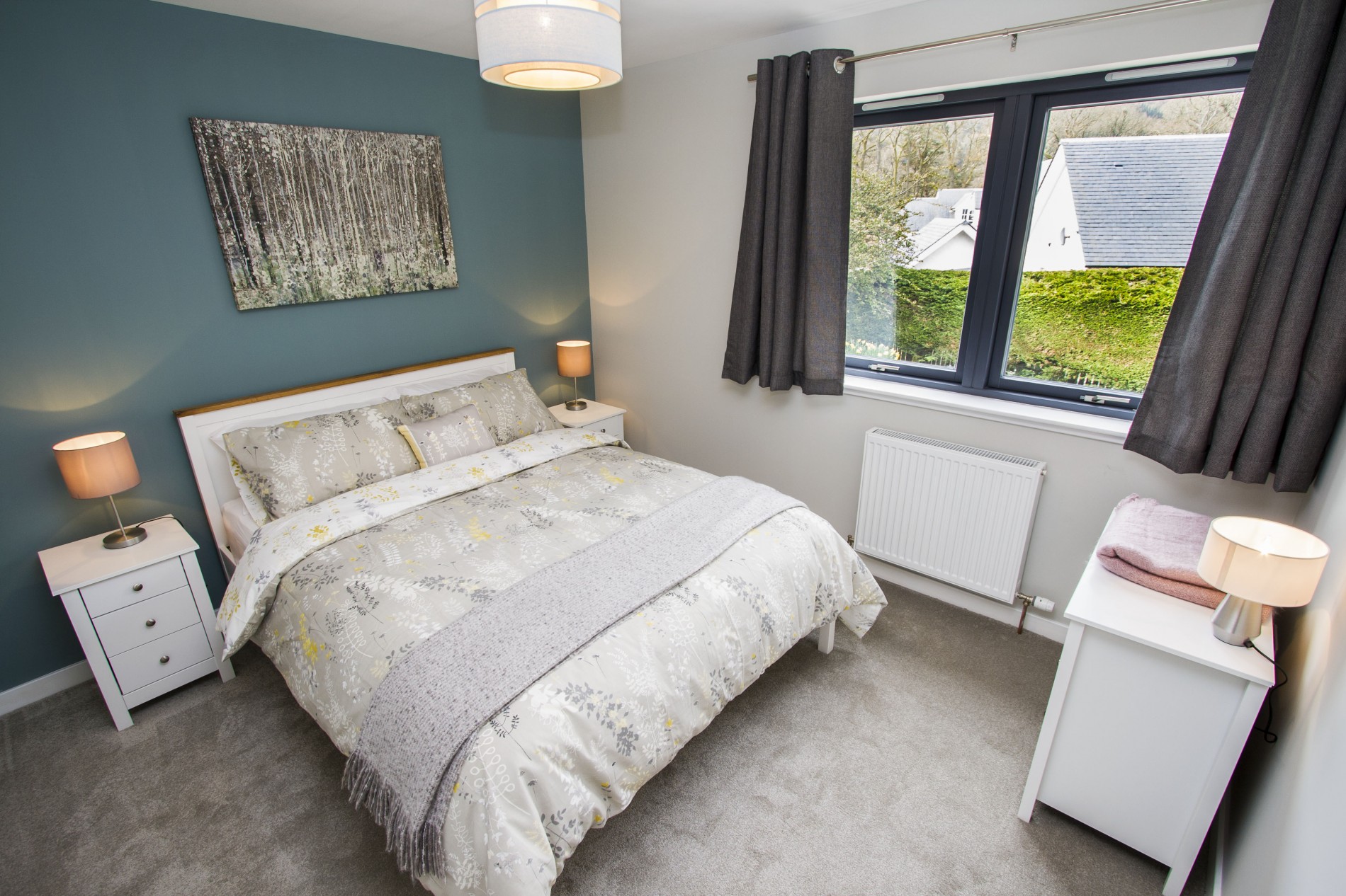 Master bedroom with large double glazed windows flooding room with natural light
