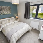 Master bedroom with large double glazed windows flooding room with natural light