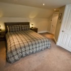 The attractive double bedroom has built in wardrobes offering excellent hanging and storage space, also a double sofa bed