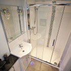 The modern en-suite is fitted with WC, wash hand basin and large walk in shower cubicle.