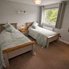 Spacious twin bedroom with two single beds. Large window makes the room bright and airy.