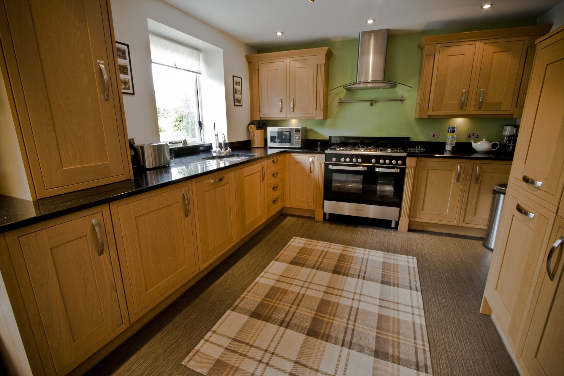 Large and attractive kitchen fitted with quality oak units and granite work surfaces. Appliances include: range oven & hob, washing machine, dishwasher, larder fridge, freezer and microwave.