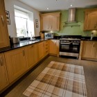 Large and attractive kitchen fitted with quality oak units and granite work surfaces. Appliances include: range oven & hob, washing machine, dishwasher, larder fridge, freezer and microwave.