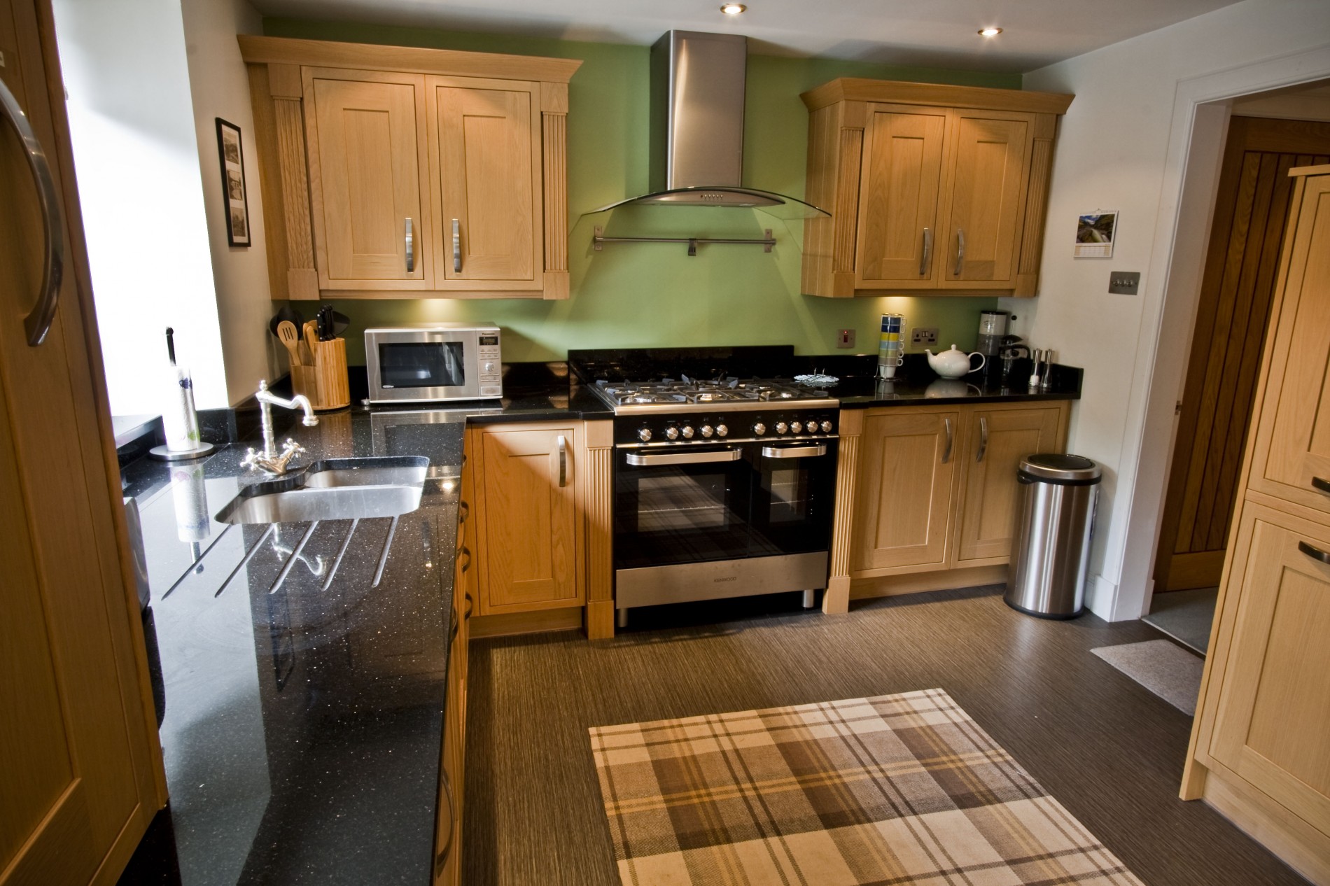 Large and attractive kitchen fitted with quality oak units and granite work surfaces. Appliances include: range oven & hob, washing machine, dishwasher, larder fridge, freezer and microwave.