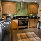 Large and attractive kitchen fitted with quality oak units and granite work surfaces. Appliances include: range oven & hob, washing machine, dishwasher, larder fridge, freezer and microwave.