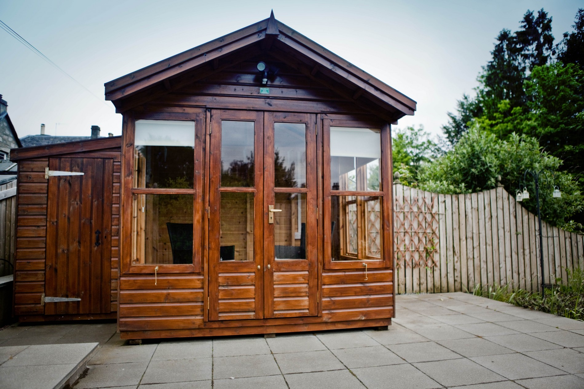 The large patio area with garden furniture enjoys lovely views of the surrounding hills while the summer house is perfect for alfresco dining and relaxing