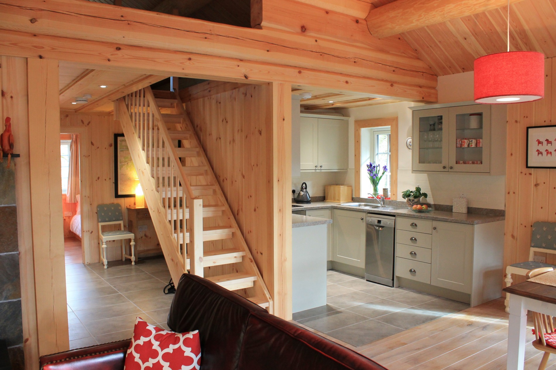 Wooden staircase looking onto kitchen