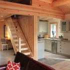Wooden staircase looking onto kitchen