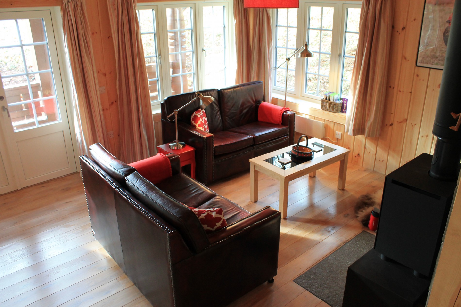 Living room with two sofas and a wood burner