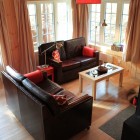 Living room with two sofas and a wood burner