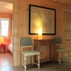 Hallway with chairs looking into bedroom