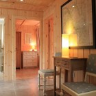 Hallway with chair looking into three rooms