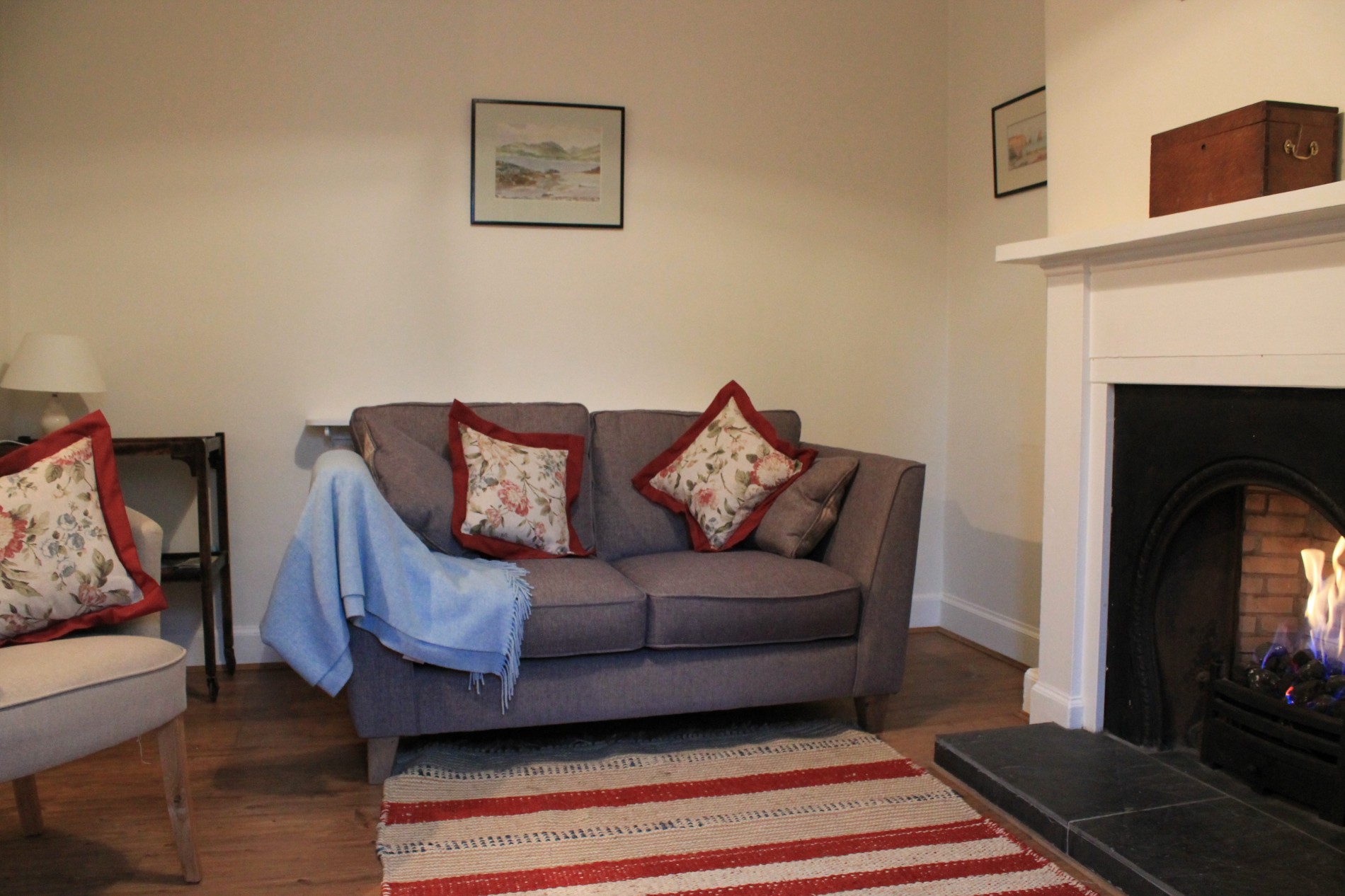 Living room with sofa, armchair and fireplace