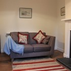 Living room with sofa, armchair and fireplace