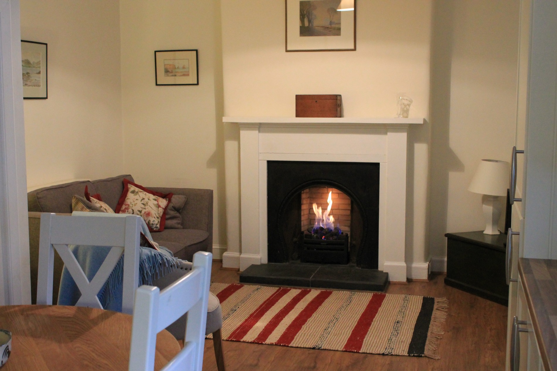 Living room with sofa, armchair and fireplace