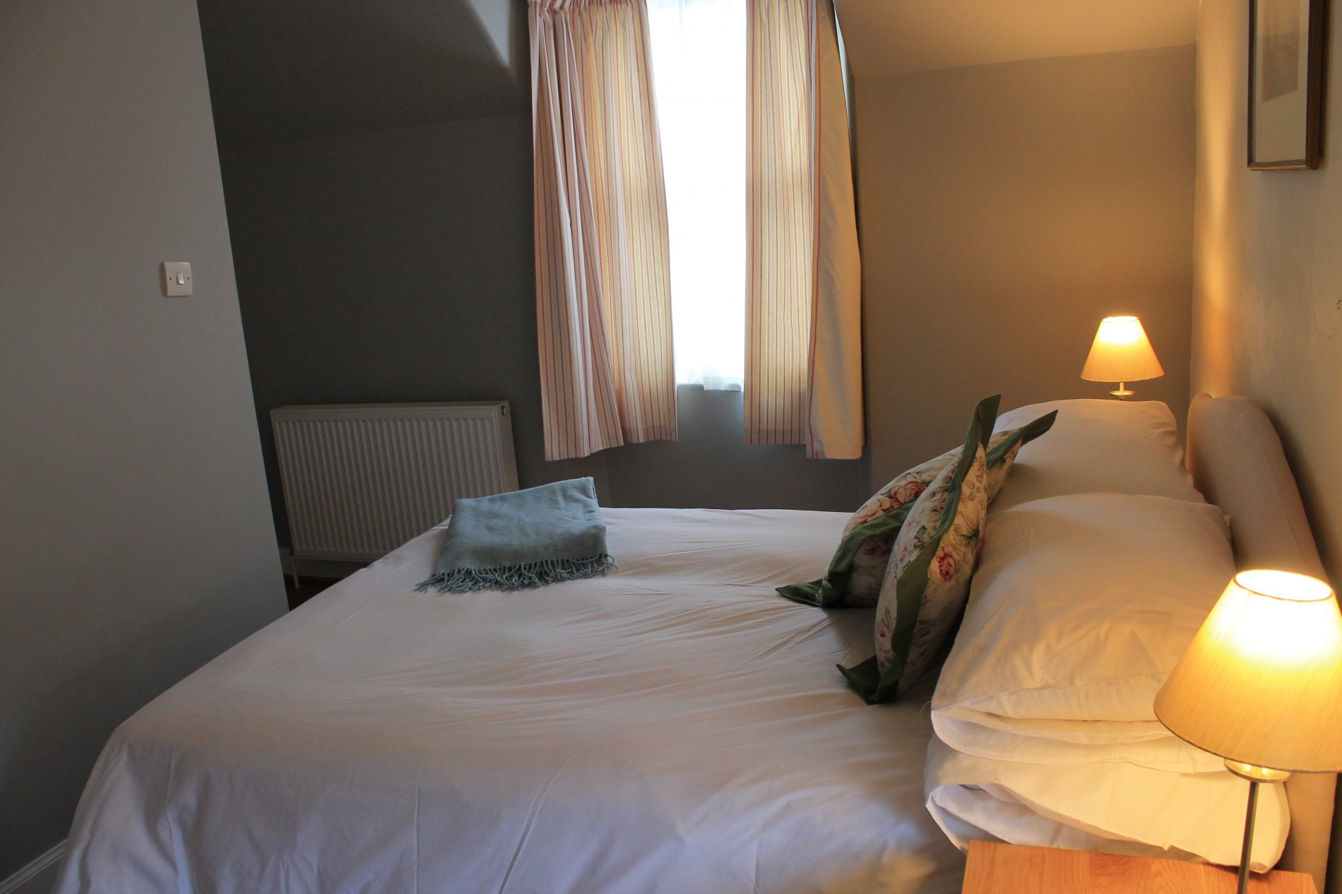 Bedroom with double bed, window and radiator