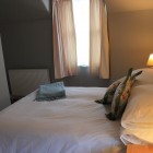 Bedroom with double bed, window and radiator