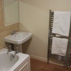 Bathroom with shower/ bath, sink, towel radiator, toilet and mirror