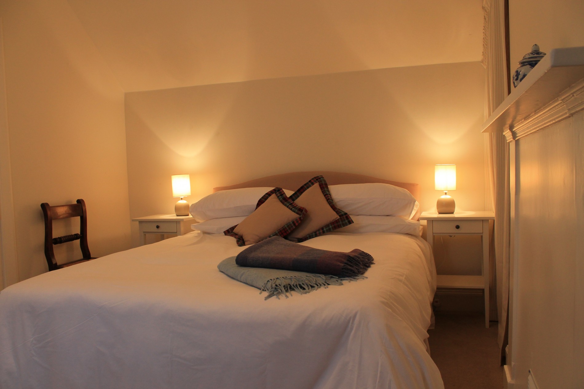 Bedroom with double bed, chair and bedside tables