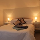 Bedroom with double bed, chair and bedside tables