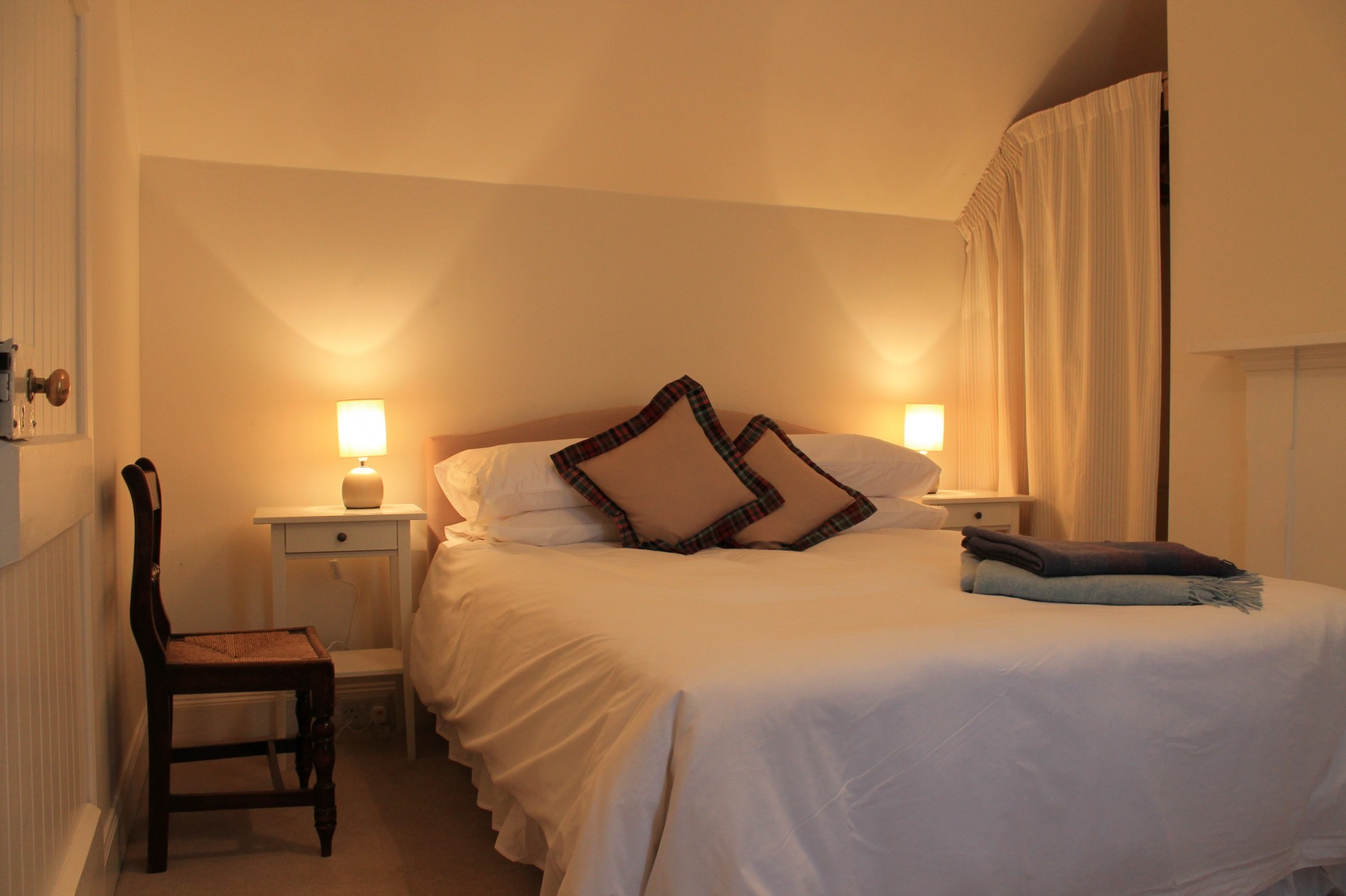 Double bedroom with bedside tables and chair