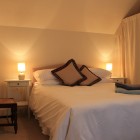 Double bedroom with bedside tables and chair