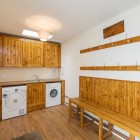 Washing room with pegs, benches, washing machine, sink and dryer